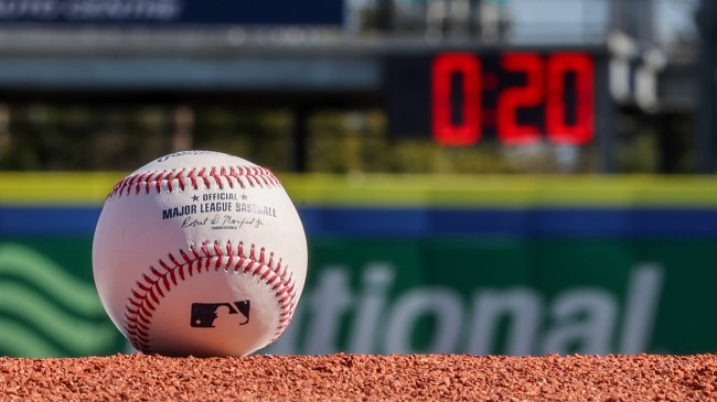 MLB baseball in front of pitch clock