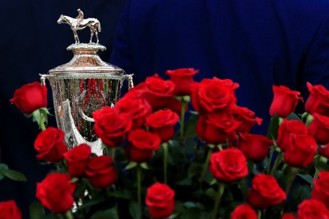 The Kentucky Derby trophy next to roses